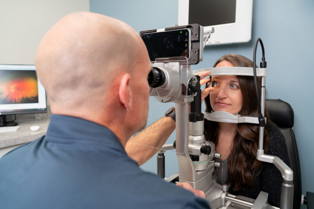 professional commercial photograph of a woman getting an eye exam in a doctors office used for marketing purposes. 